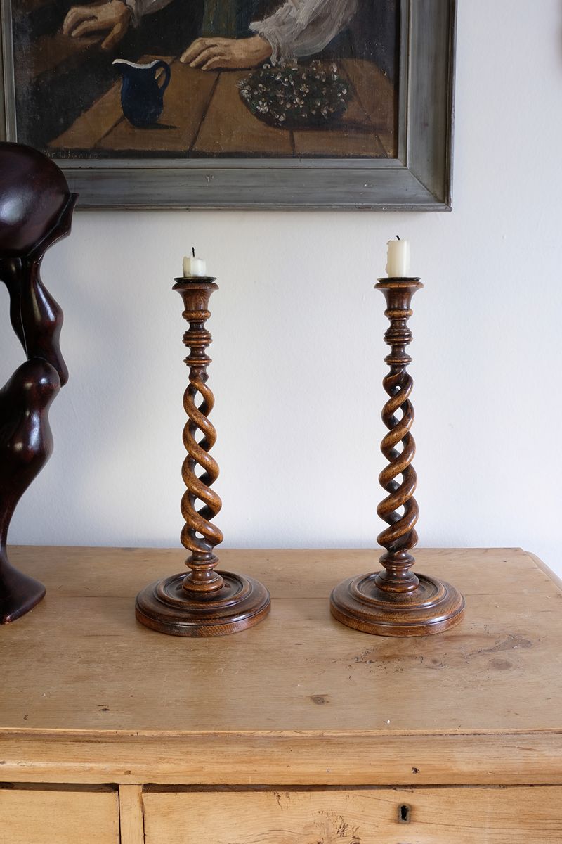 Pair of tall antique oak open barley twist candlesticks with original brass sconces and weighted circular bases