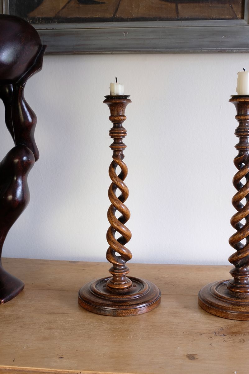 Pair of tall antique oak open barley twist candlesticks with original brass sconces and weighted circular bases