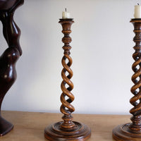 Pair of tall antique oak open barley twist candlesticks with original brass sconces and weighted circular bases