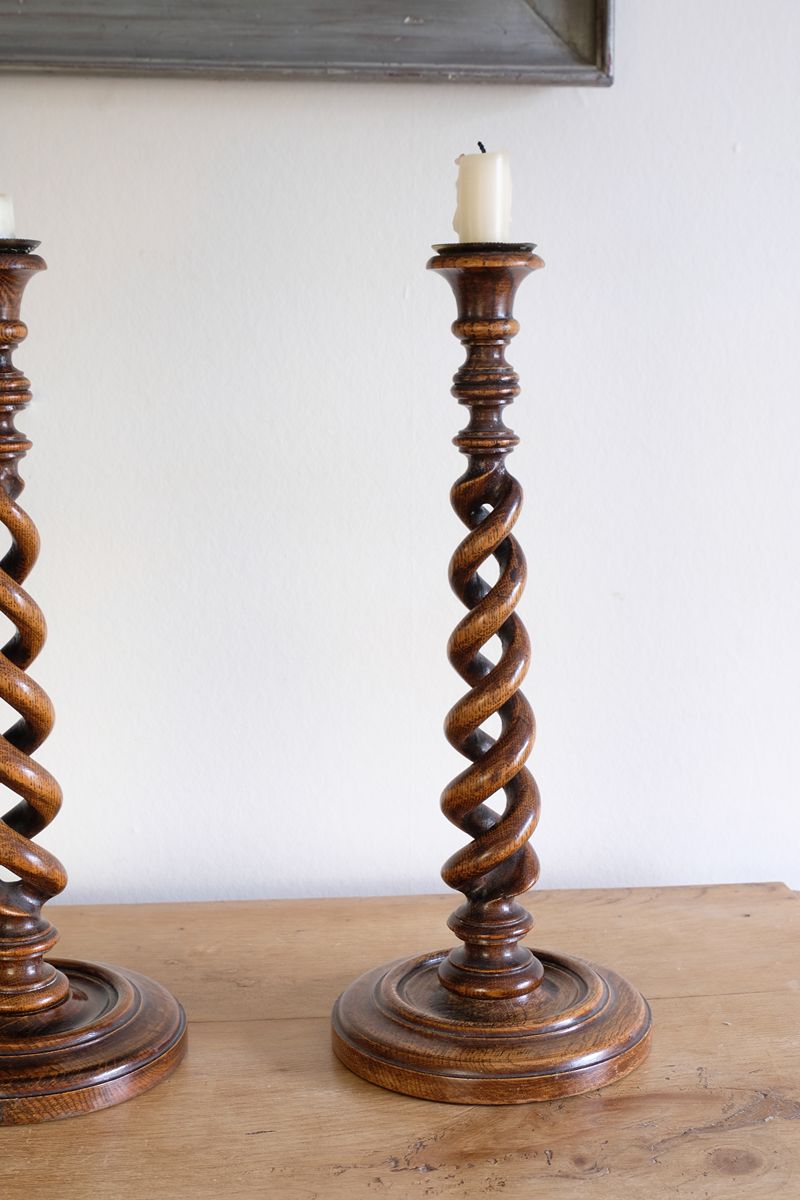 Pair of tall antique oak open barley twist candlesticks with original brass sconces and weighted circular bases