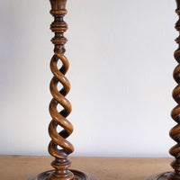 Pair of tall antique oak open barley twist candlesticks with original brass sconces and weighted circular bases