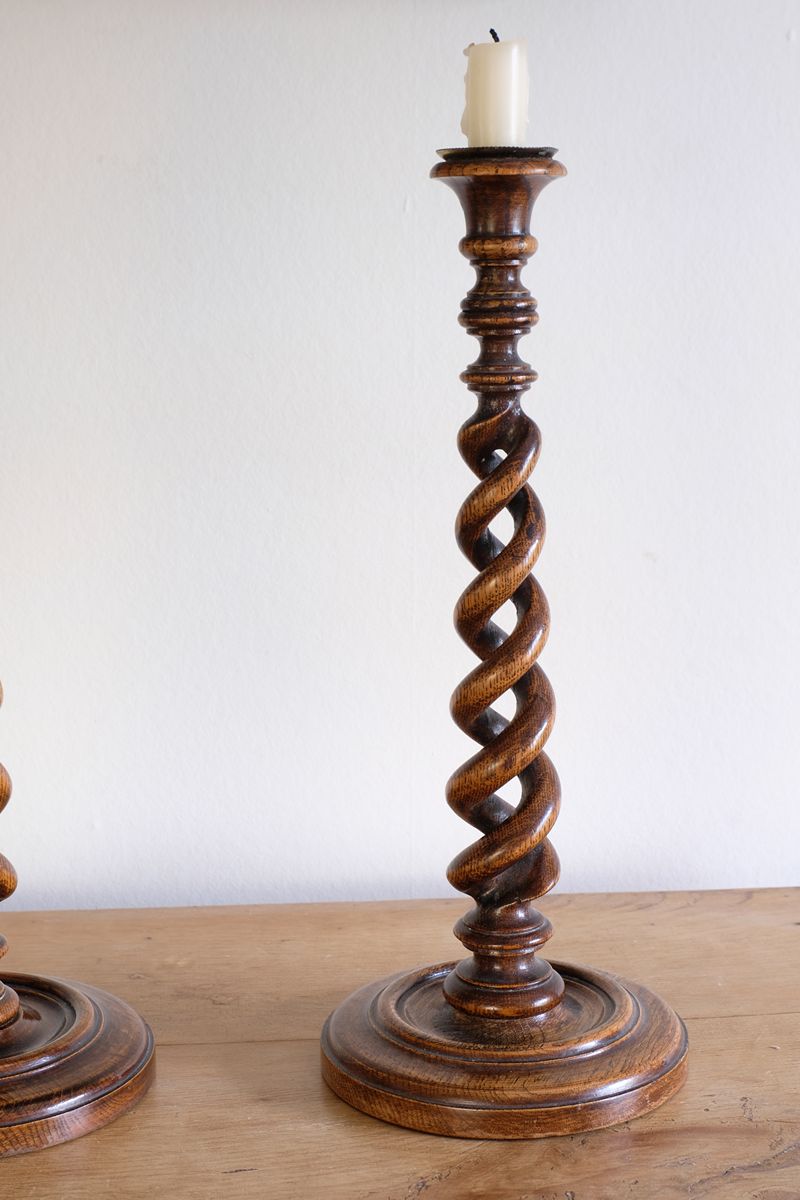 Pair of tall antique oak open barley twist candlesticks with original brass sconces and weighted circular bases
