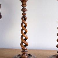 Pair of tall antique oak open barley twist candlesticks with original brass sconces and weighted circular bases