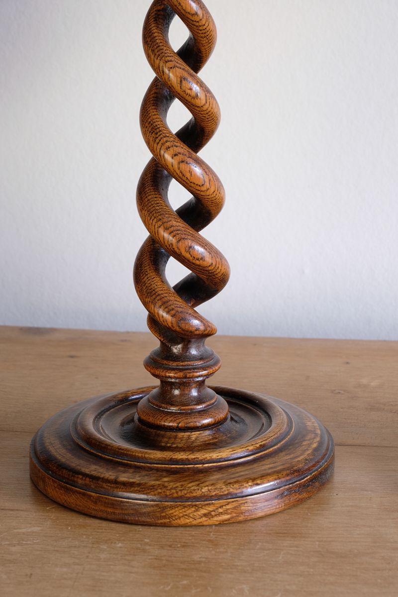 Pair of tall antique oak open barley twist candlesticks with original brass sconces and weighted circular bases