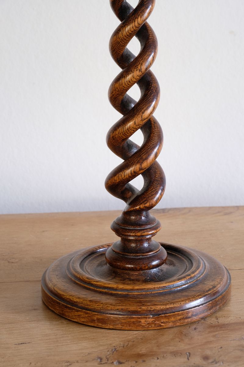 Pair of tall antique oak open barley twist candlesticks with original brass sconces and weighted circular bases