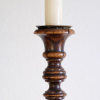 Sconce detail on a Pair of tall antique oak open barley twist candlesticks with original brass sconces and weighted circular bases