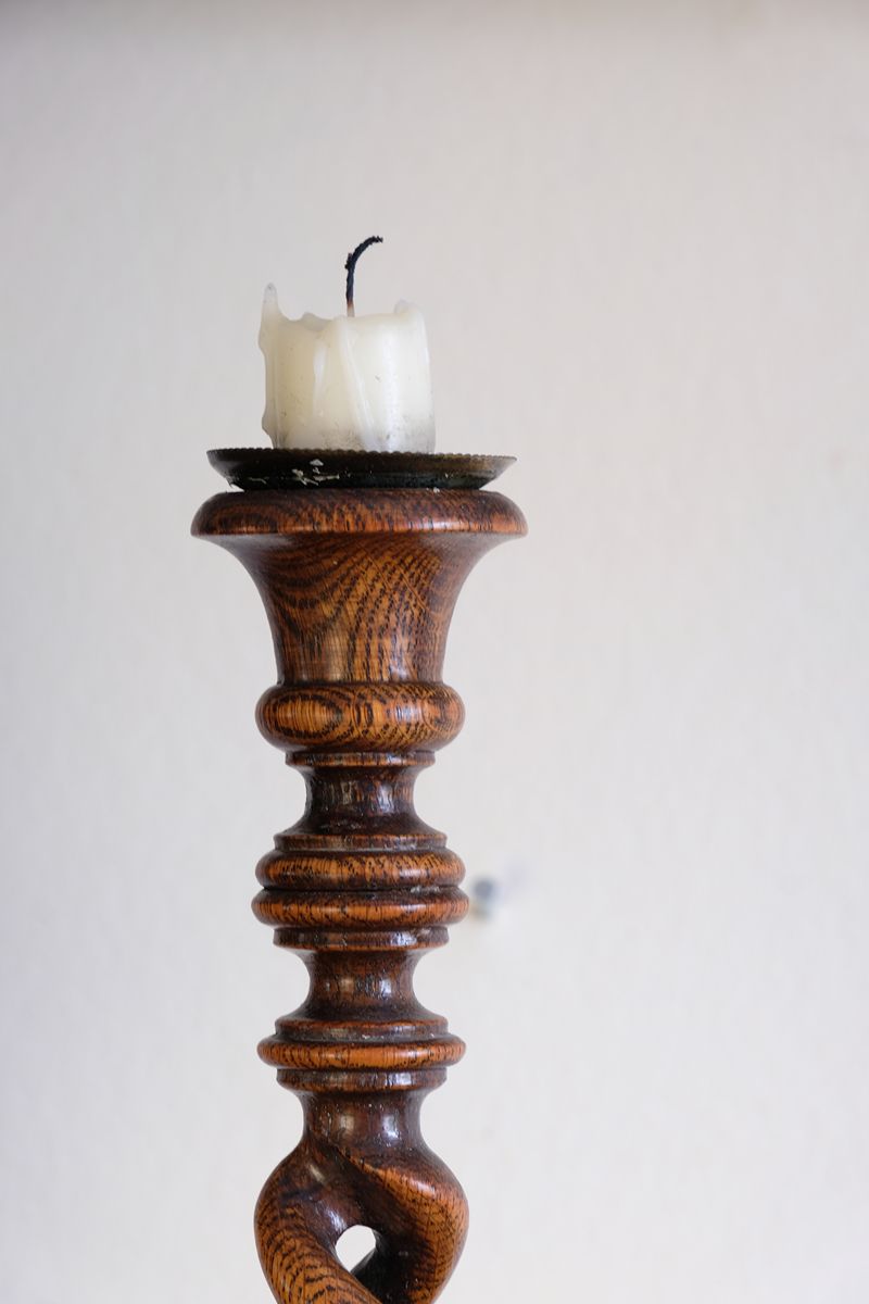 Pair of tall antique oak open barley twist candlesticks with original brass sconces and weighted circular bases