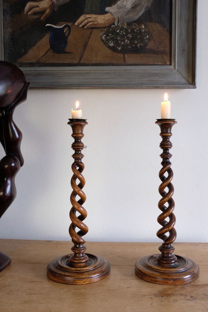 Pair of tall antique oak open barley twist candlesticks with original brass sconces and weighted circular bases