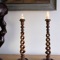 Pair of tall antique oak open barley twist candlesticks with original brass sconces and weighted circular bases