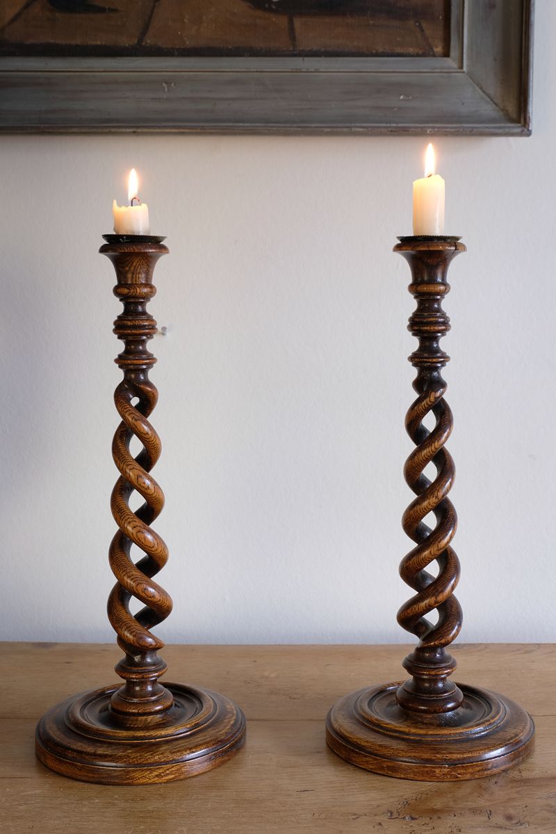 Pair of tall antique oak open barley twist candlesticks with original brass sconces and weighted circular bases