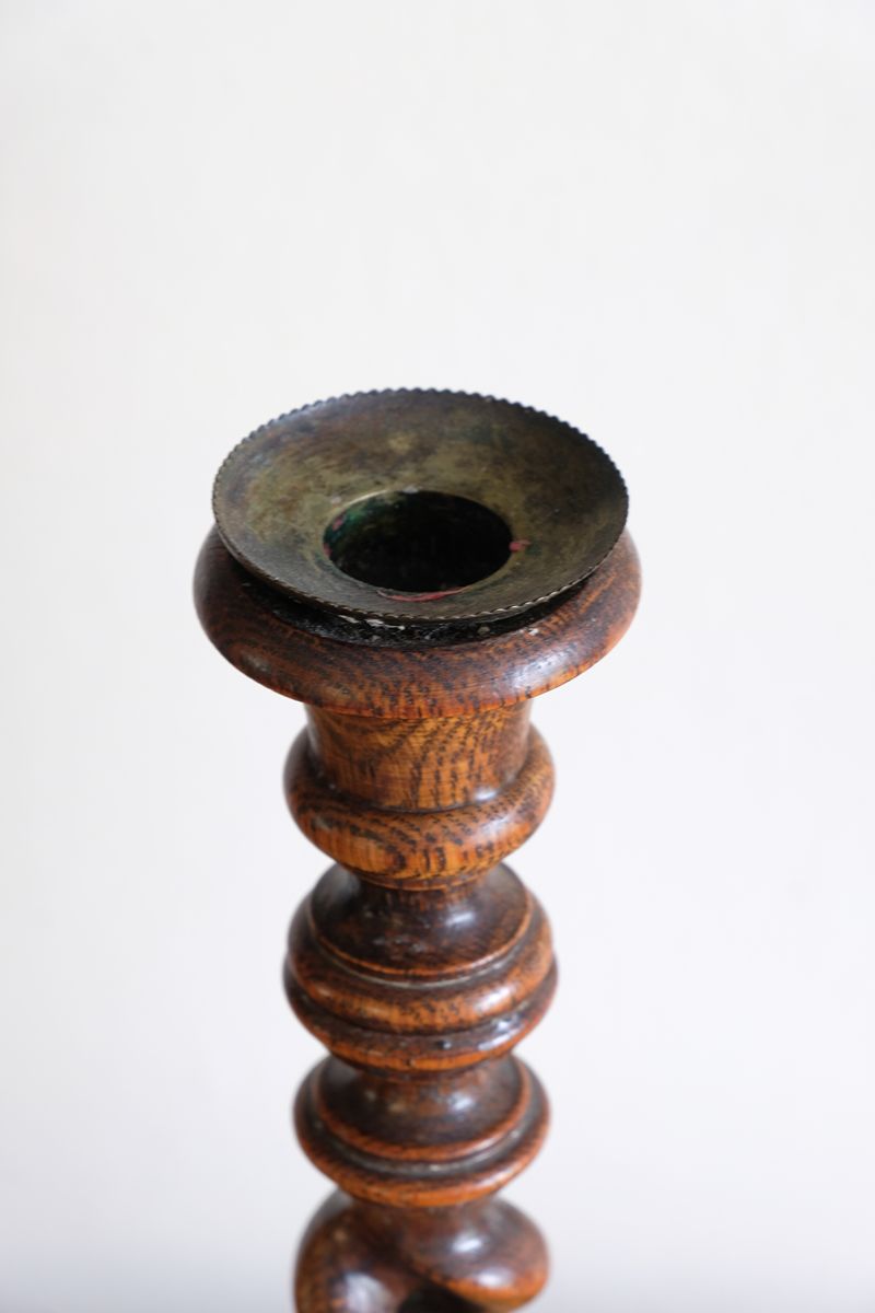 Pair of tall antique oak open barley twist candlesticks with original brass sconces and weighted circular bases