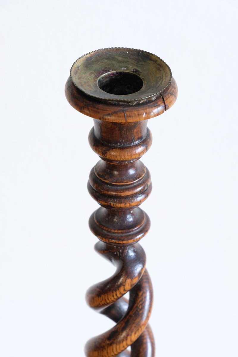Pair of tall antique oak open barley twist candlesticks with original brass sconces and weighted circular bases