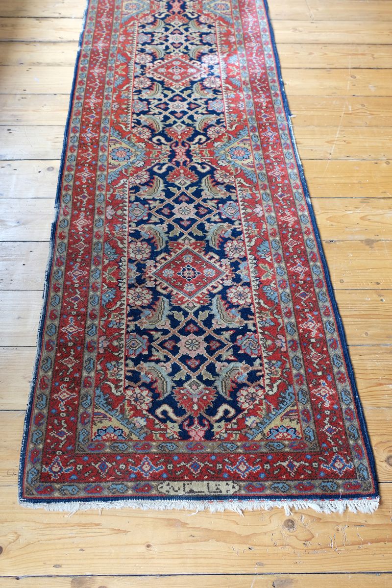 Indigo field and repeating diamond medallions of the Persian runner