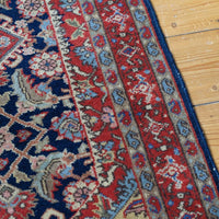 Hand-knotted floral lattice surrounding the geometric field medallions