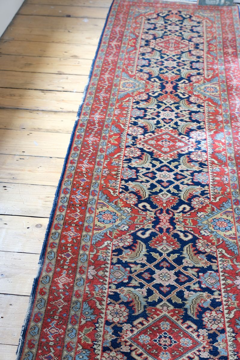 Red floral main border with camel and pale blue guard borders