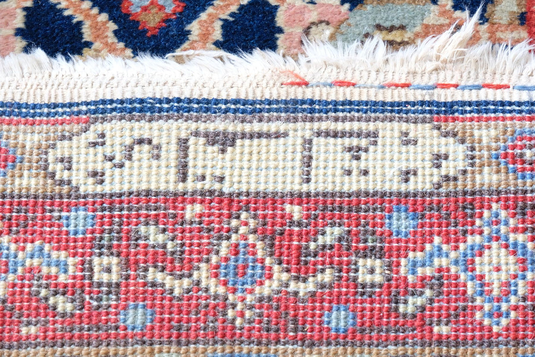 Woven Persian inscription within the ivory end cartouche of the antique runner
