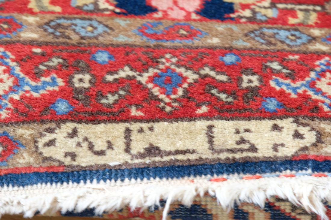 Woven Persian inscription within the ivory end cartouche of the antique runner