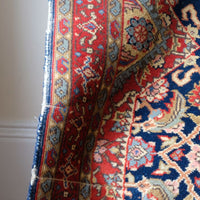 Red floral main border with camel and pale blue guard borders
