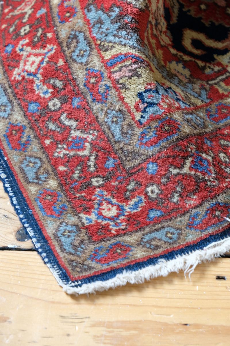 Corner detail showing the hand-knotted borders and dark-blue side binding