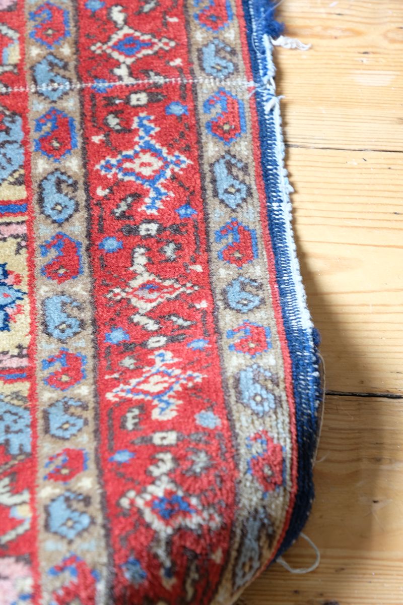 visible natural wear on this Red floral main border with camel and pale blue guard borders