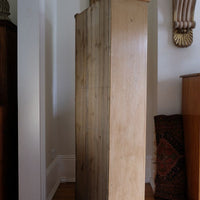 side panel on the Antique pine cupboard, circa 1890–1910, with a boarded door, two pierced ventilation panels and a plinth base