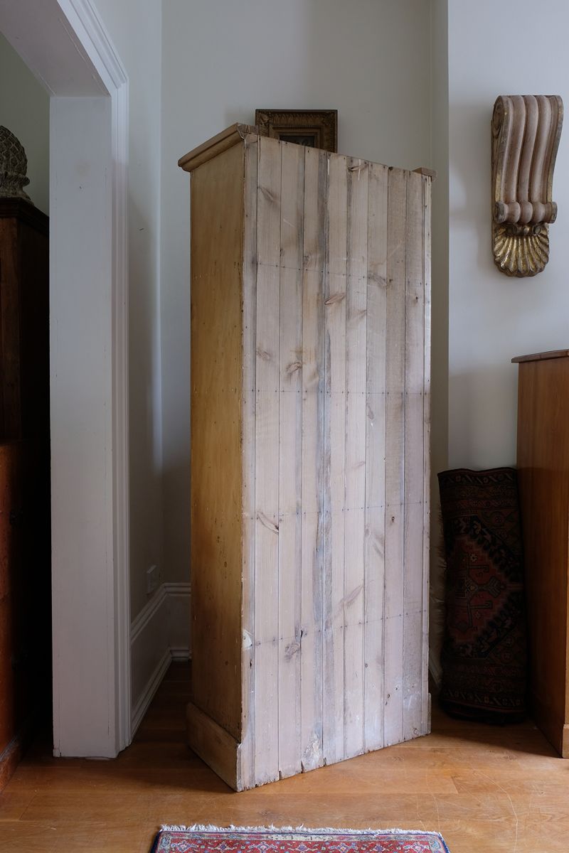 tongue and grooved back n the Antique pine cupboard, circa 1890–1910, with a boarded door, two pierced ventilation panels and a plinth base