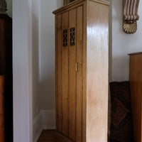 Antique pine cupboard, circa 1890–1910, with a boarded door, two pierced ventilation panels and a plinth base