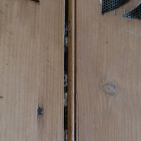 Antique pine cupboard, circa 1890–1910, with a boarded door, two pierced ventilation panels and a plinth base