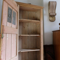 inside the Antique pine cupboard, circa 1890–1910, with a boarded door, two pierced ventilation panels and a plinth base
