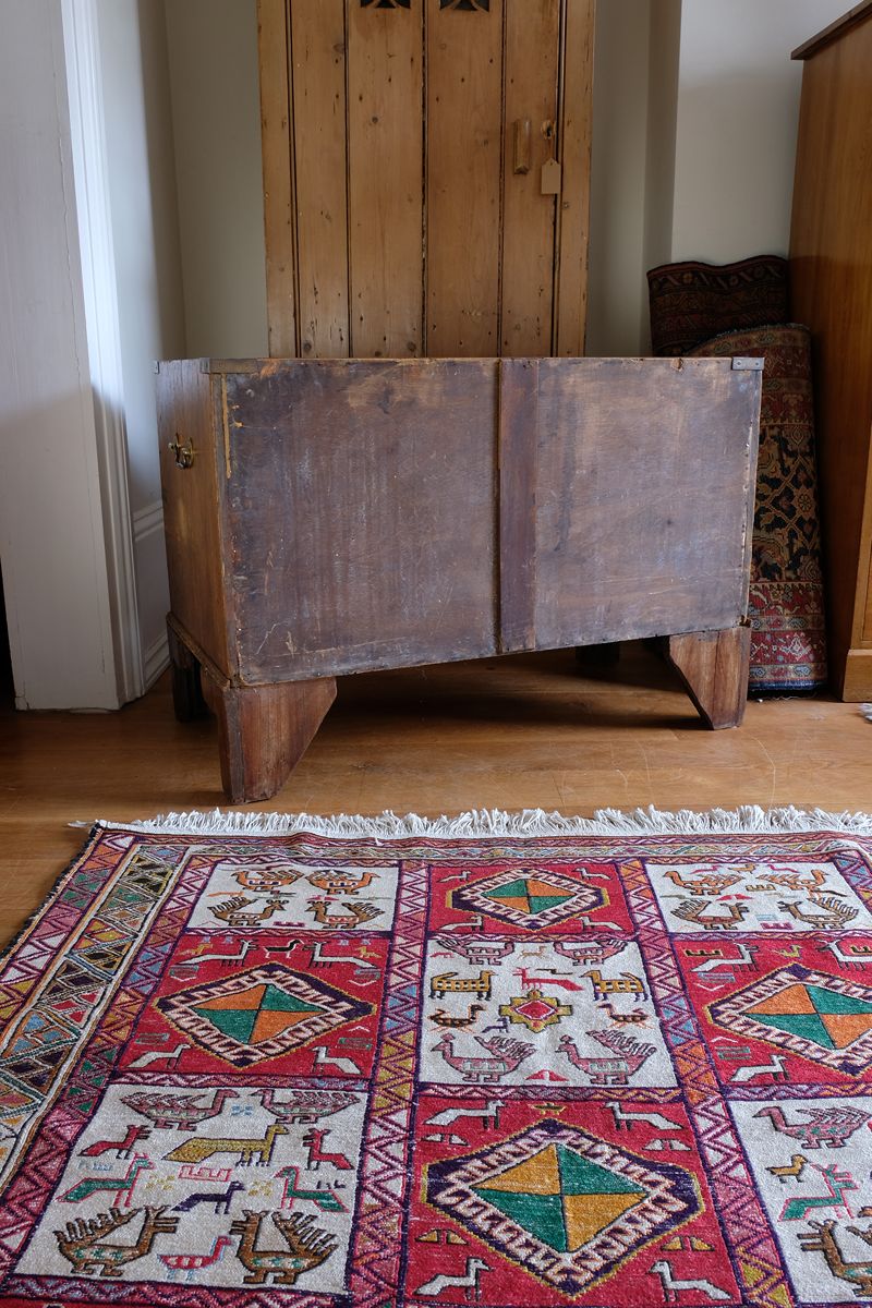 Rear of two-drawer campaign chest showing thin solid timber boards and central strip