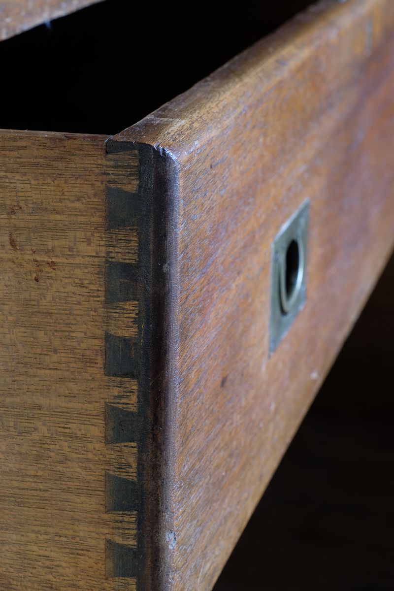 Open drawers of mahogany campaign chest showing dovetailed timber construction
