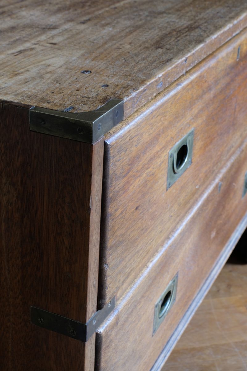 Close view of rounded drawer front and recessed brass campaign pull
