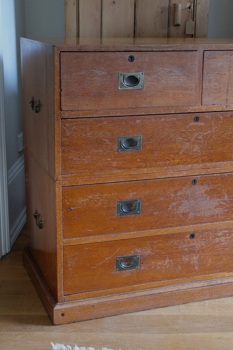 Antique campaign chest showing extensive original surface wear and aged camphor wood.