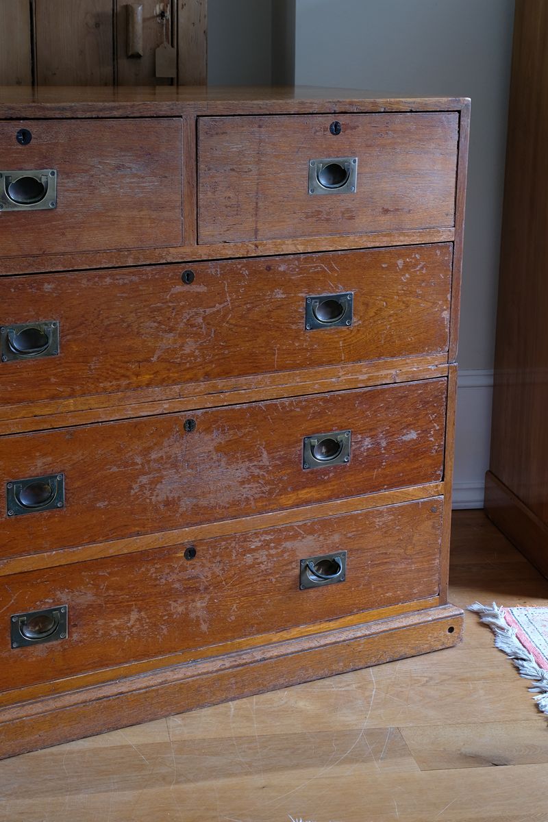 Two-part Victorian campaign chest showing folding side carrying handles.