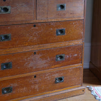Two-part Victorian campaign chest showing folding side carrying handles.