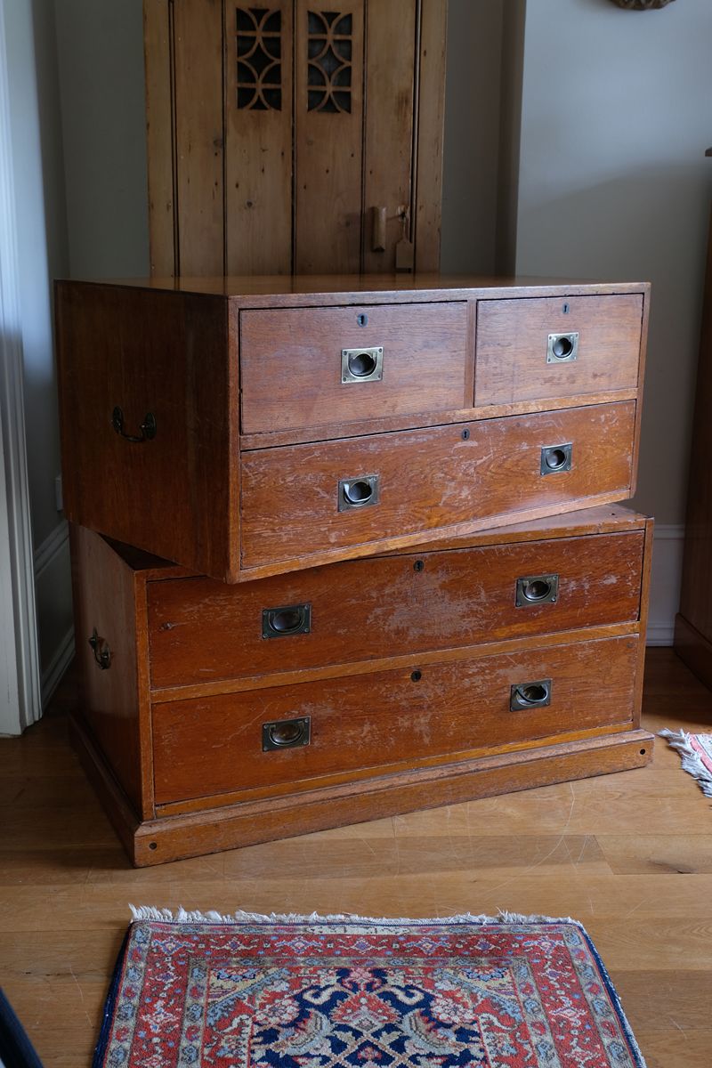 Two-part Victorian campaign chest showing folding side carrying handles.