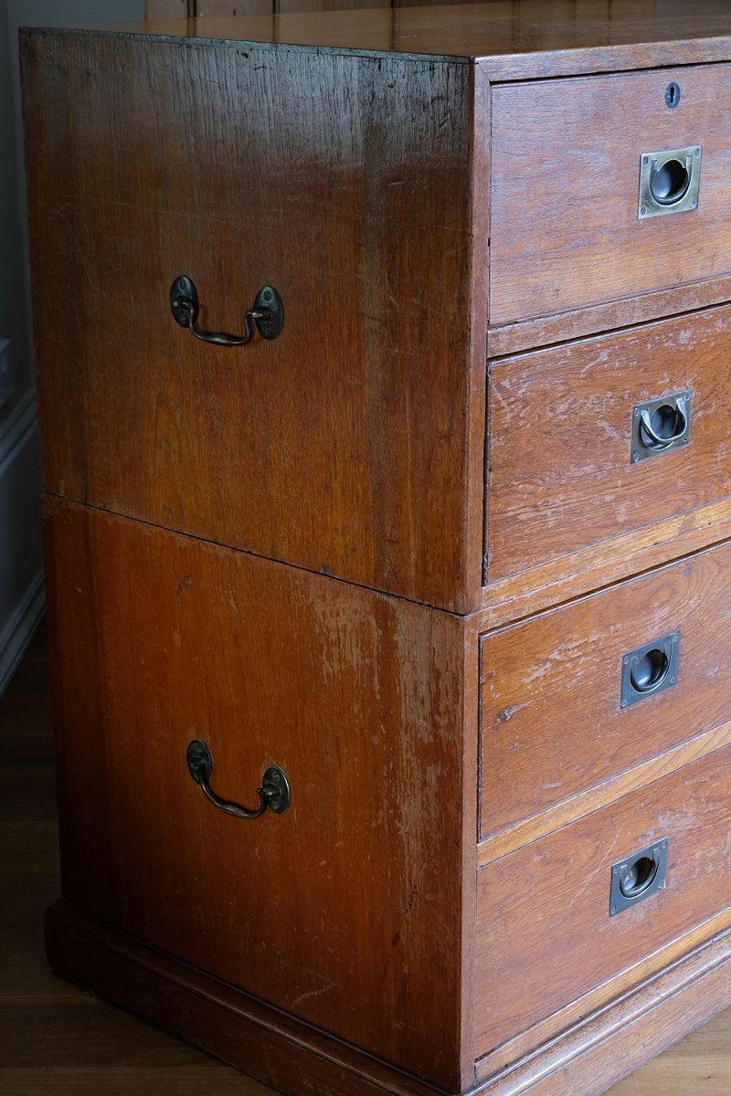 Close-up of recessed brass campaign drawer handle and original keyhole escutcheon.