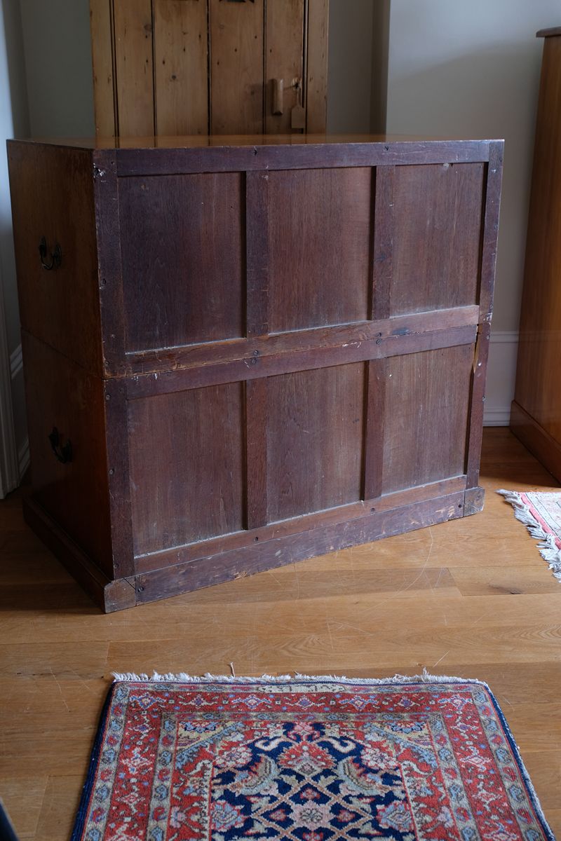 Rear of antique camphor wood campaign chest showing three-panel framed construction to both sections.
