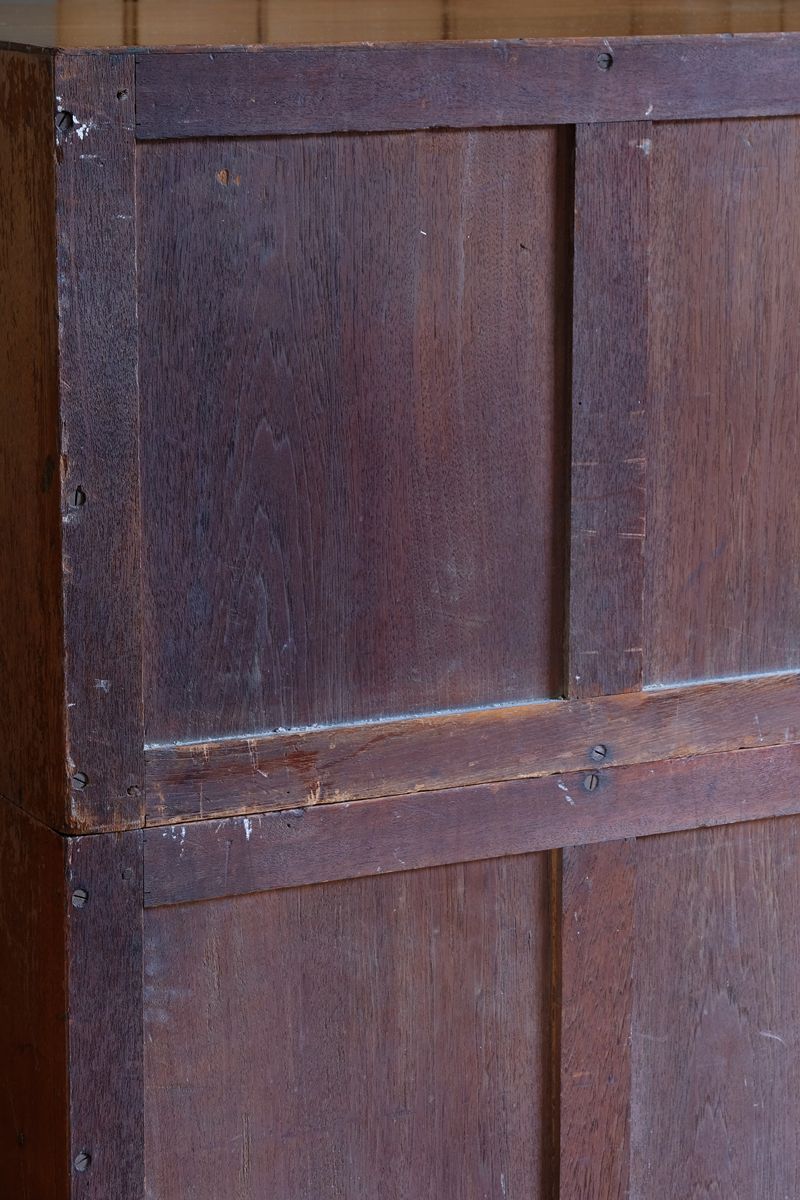 Rear of antique camphor wood campaign chest showing three-panel framed construction to both sections.
