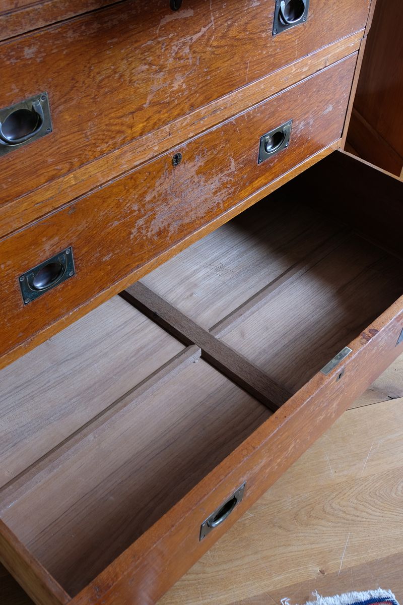 Open antique campaign chest drawer showing reinforced solid timber bottom and cross-bracing.