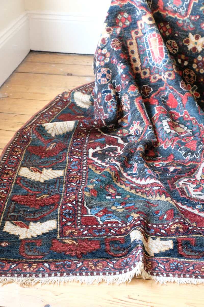Early 20th century Persian Qashqai wool rug with indigo field, three medallions and blue-green corners, 244 × 159 cm
