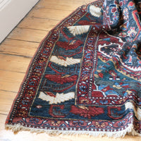 Early 20th century Persian Qashqai wool rug with indigo field, three medallions and blue-green corners, 244 × 159 cm