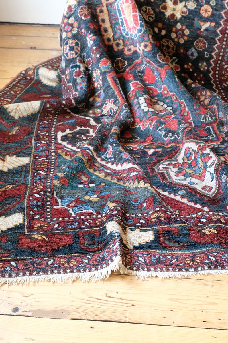 Early 20th century Persian Qashqai wool rug with indigo field, three medallions and blue-green corners, 244 × 159 cm