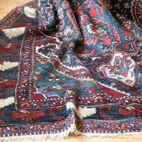 Early 20th century Persian Qashqai wool rug with indigo field, three medallions and blue-green corners, 244 × 159 cm