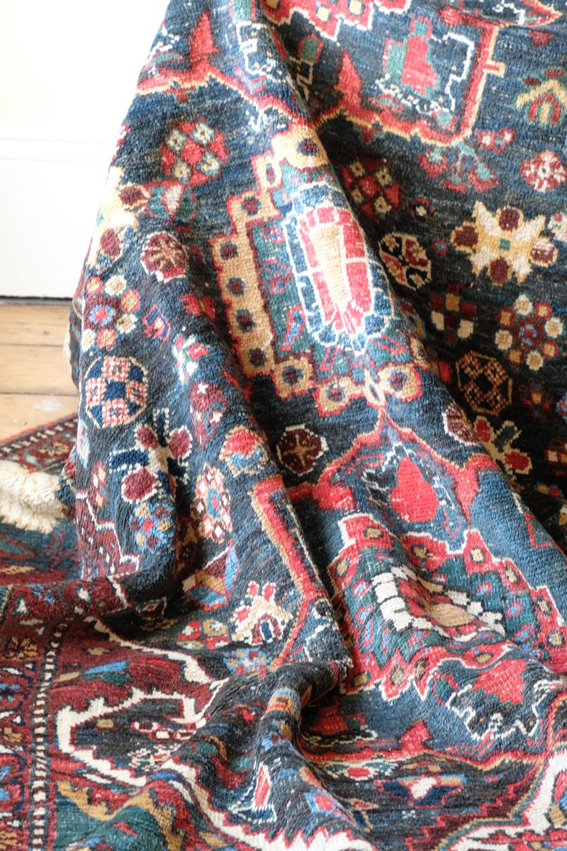 Early 20th century Persian Qashqai wool rug with indigo field, three medallions and blue-green corners, 244 × 159 cm
