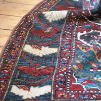 Early 20th century Persian Qashqai wool rug with indigo field, three medallions and blue-green corners, 244 × 159 cm