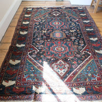 Early 20th century Persian Qashqai wool rug with indigo field, three medallions and blue-green corners, 244 × 159 cm