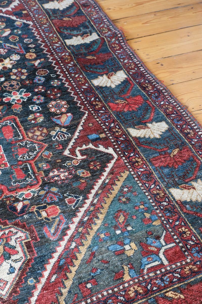 Early 20th century Persian Qashqai wool rug with indigo field, three medallions and blue-green corners, 244 × 159 cm
