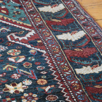 Early 20th century Persian Qashqai wool rug with indigo field, three medallions and blue-green corners, 244 × 159 cm
