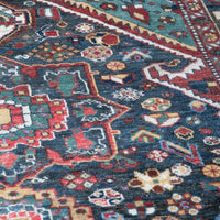 Early 20th century Persian Qashqai wool rug with indigo field, three medallions and blue-green corners, 244 × 159 cm